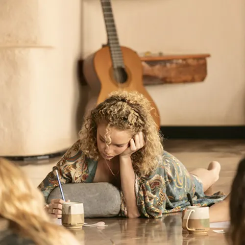 Student journaling during reflection time at 200-hour yoga teacher training.