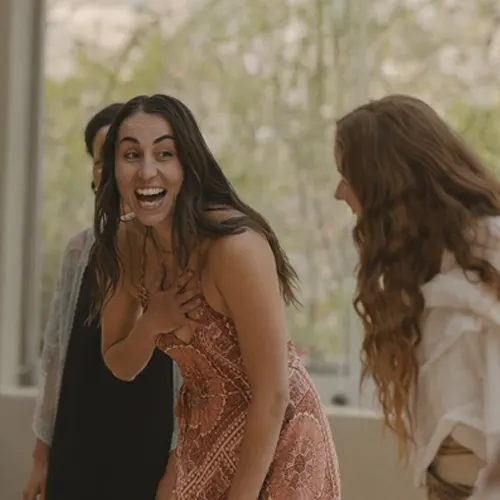 Students sharing joy and laughter at 200-hour yoga teacher training.