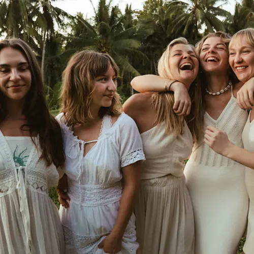 Group of women smiling and hugging during Bali Yoga Teacher Training